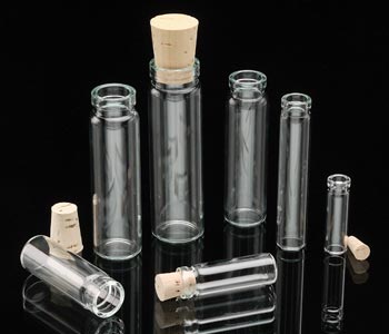 clear patent lip glass vials with wooden corks with black background