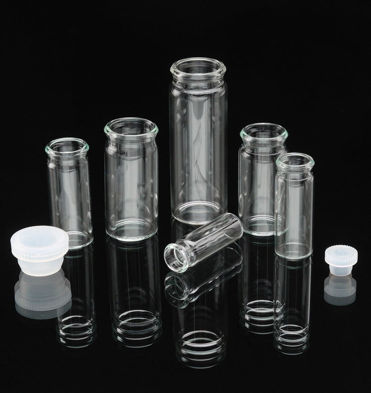 clear display glass vials with cap closure in front of black background